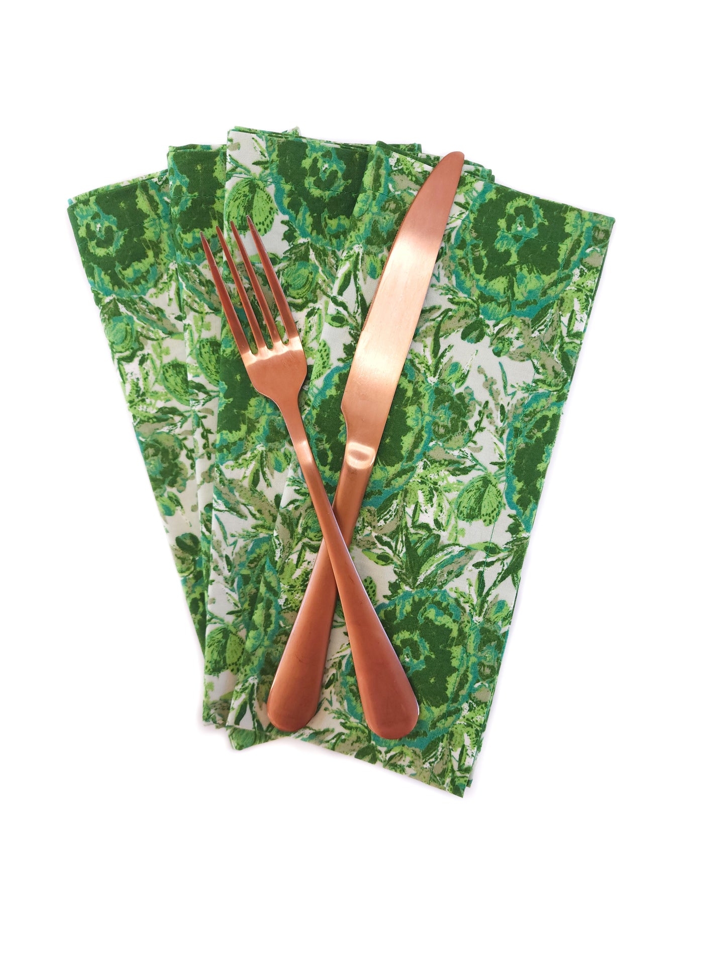 Set of four green patterned napkins with a fork and knife on a white background