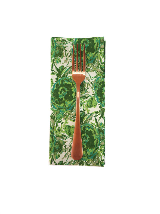 Bronze fork on a green floral-patterned napkin