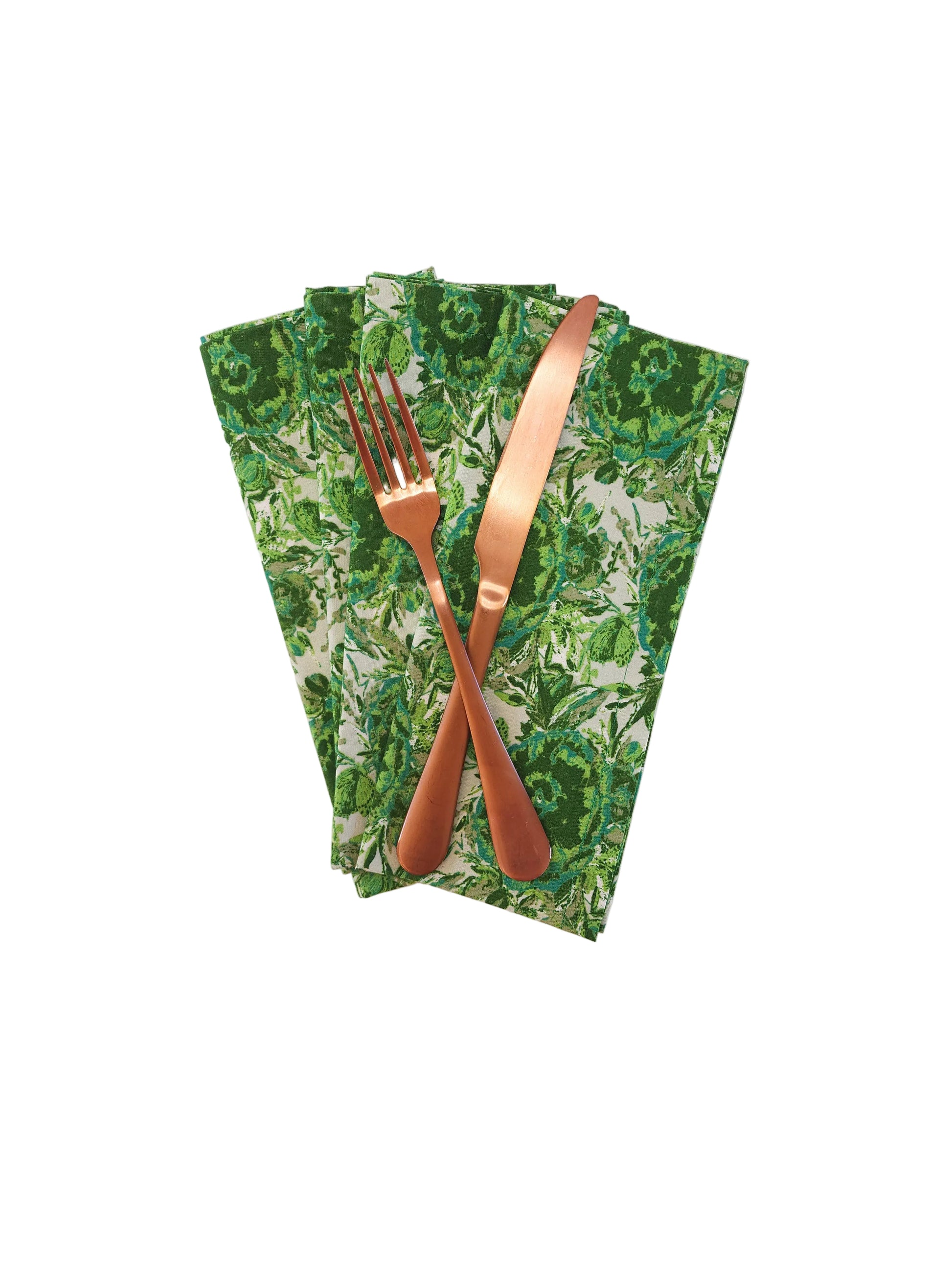 Green floral napkins with a copper fork and knife on a white background
