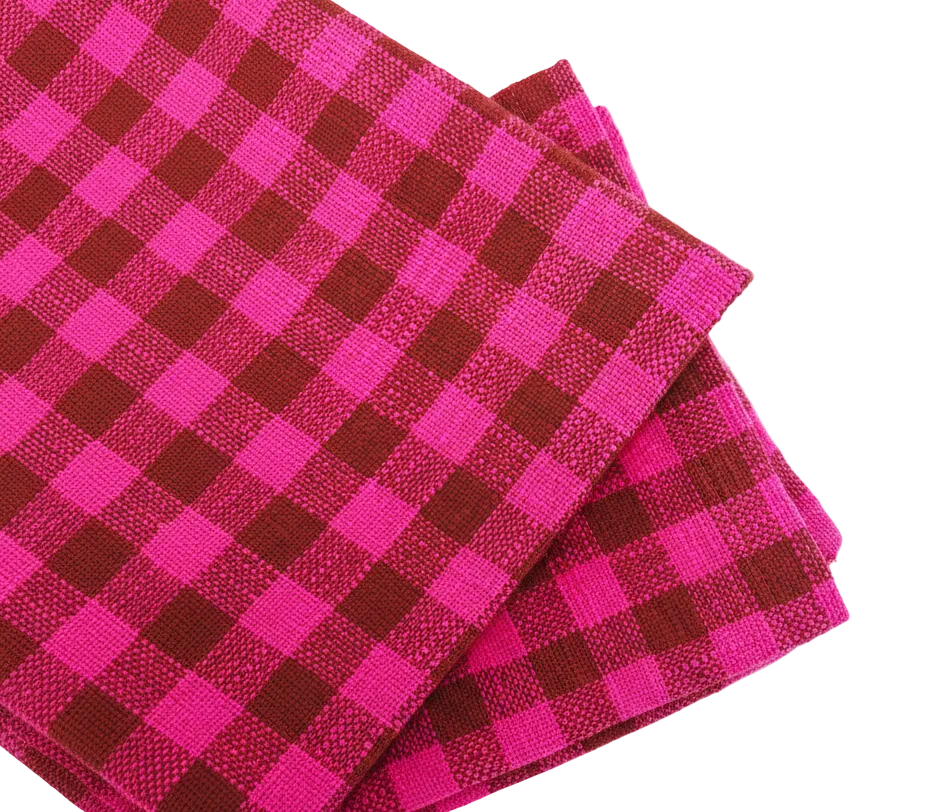 Close-up of a pink and brown checkered towel on a white background