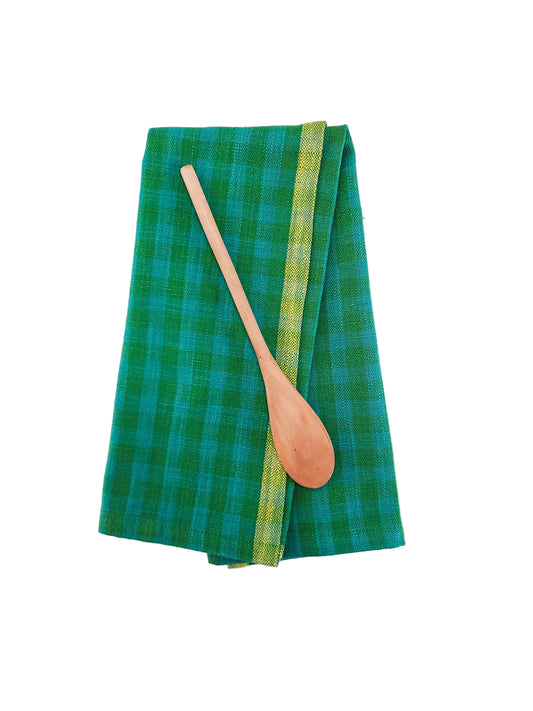 Green checkered towel with a wooden spoon on a white background