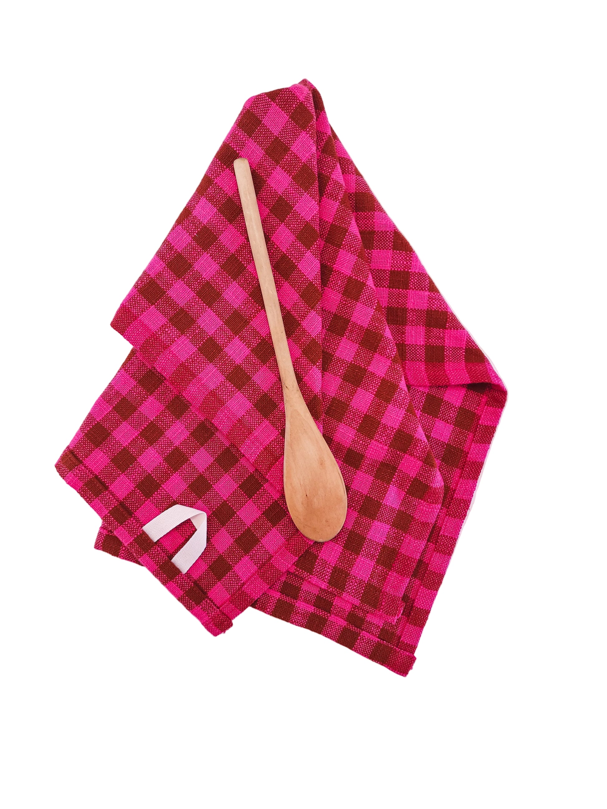 Pink and brown checkered towel with a wooden spoon on a white background