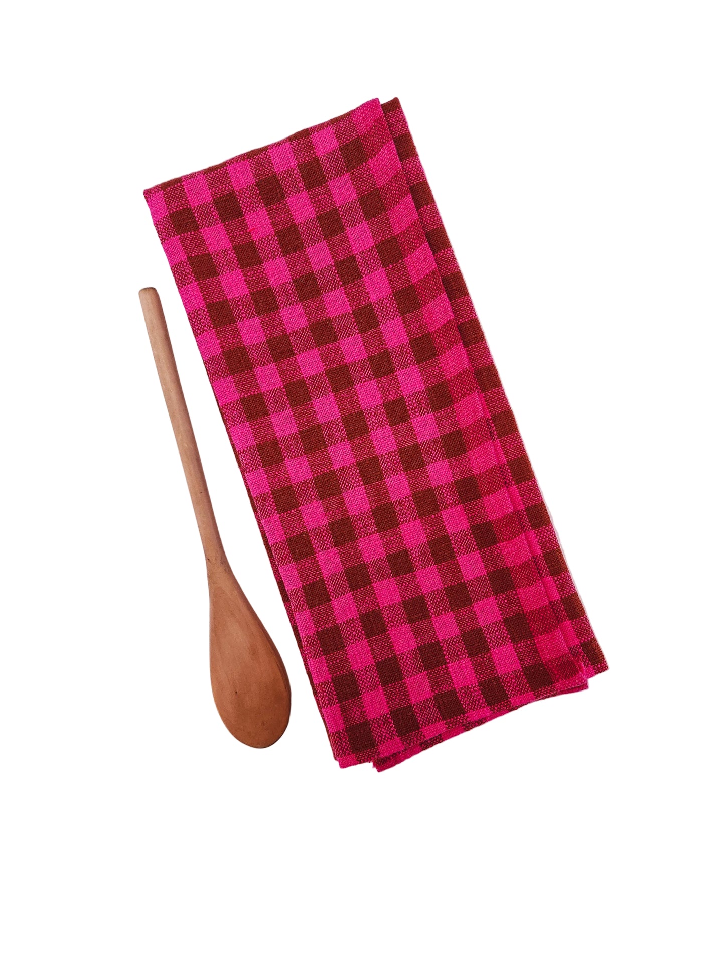 Pink and brown checkered towel with a wooden spoon on a white background